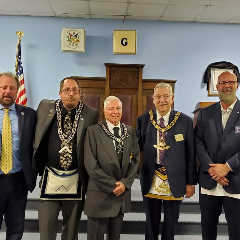 David Downs, Will Bryan, Wes Hammock, the Grand Master of the Grand Lodge of Virginia, and James Galliday post for a photograph after being presented with pins for years of service and a merit award.