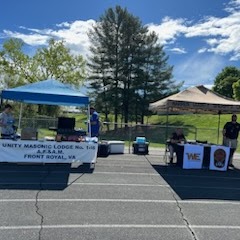 The local Masonic lodge has a canopy booth setup next to the Warren County Sheriff's Office at the All Children Matter Jubilee on April 15, 2023.