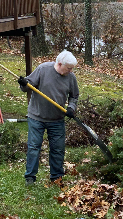 Bill Wheat raking leaves