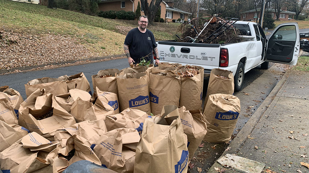 Brother Anthony looks over 30 bags of leaves