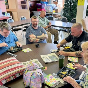Brothers Lewie & Anthony enjoy Mothers Day lunch with a senior and Lieutenant Terry at the Senior Center on May 16, 2023.