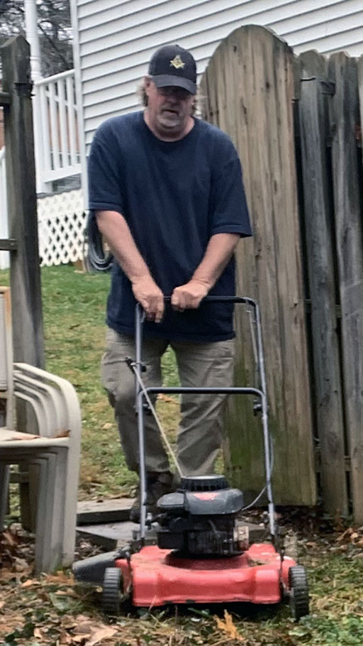 Scott Truax operating a lawn mower