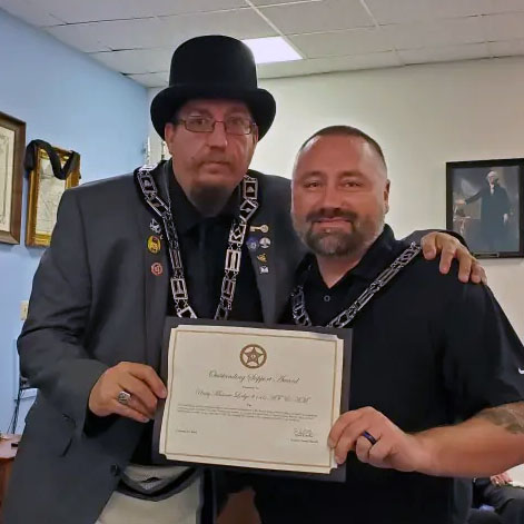 Worshipful Master William Bryan proudly accepted the Warren County Sheriff's Office Community Service Award from Lieutenant Terry Fritts.