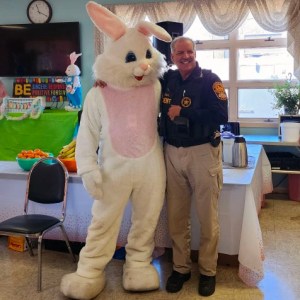 Warren County Sheriff Deputy posing with the Easter Bunny at the Warren County Senior Center on April 4, 2023.