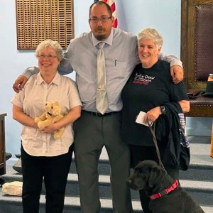 Will Bryan poses with Peggy Law of Service Dogs of Virginia on September 6, 2023