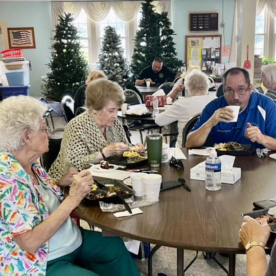 Worshipful Master WIll Bryan of Unity Masonic Lodge No 146 sits among a table of seniors enjoying his meal at Warren County Senior Center on August 11, 2023