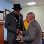 Worshipful Master Will Bryan shakes Dale Perry's hand after presenting him with his working tools on March 29, 2023