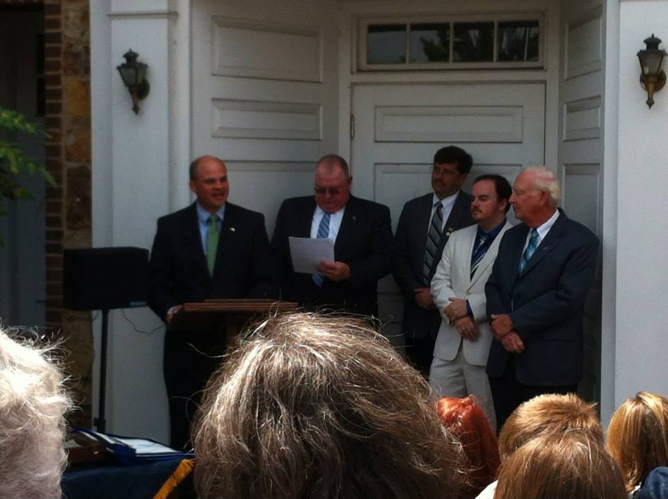 Bret reads the cornerstone's contents.