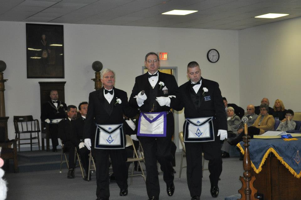 Brother Davidson escorts Bill Wheat (Junior Deacon) and Joe Plazio (Senior Deacon)