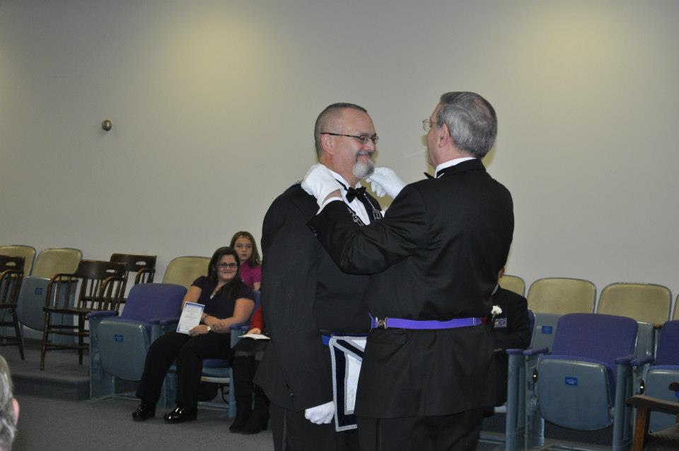 Brother Davidson presents Brother Haas with the jewels of the office.