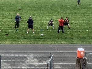 Children performing drills on a field at the 1st annual football camp an April 17, 2021.