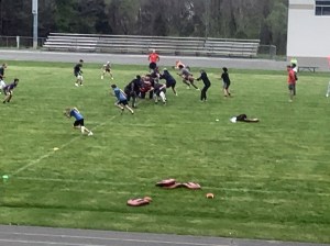Children running on a field at the 1st annual football camp on April 17, 2021.