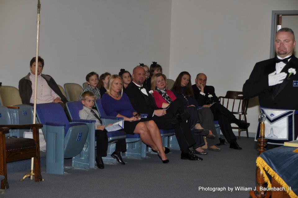 Family members gather to watch the ceremony.