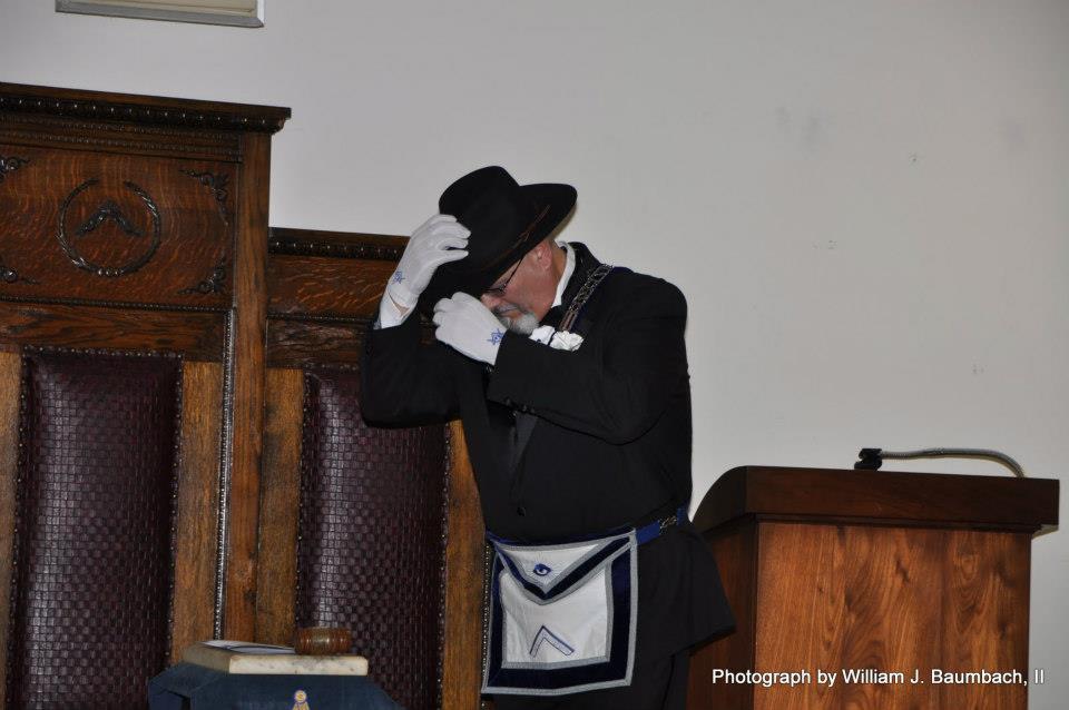 Newly installed Worshipful Master Dennis Haas dons his hat.
