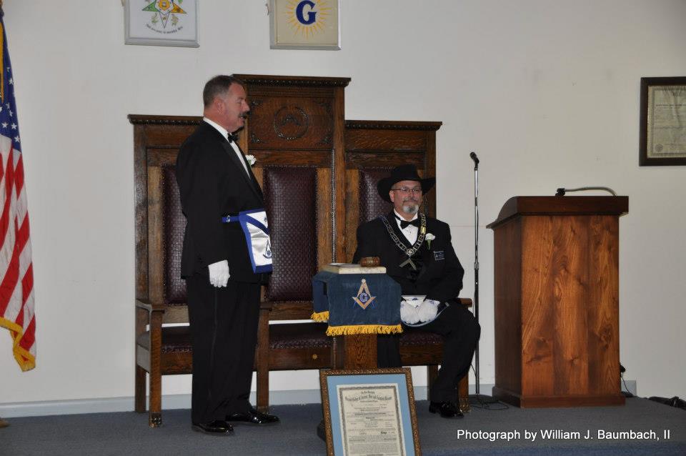 Newly installed Worshipful Master Dennis Haas sits in the East