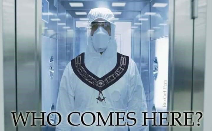 During the pandemic, a photograph of a man in a white biohazard suite wearing a collar of freemasonry asks, "Who comes here?"