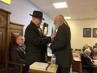 Worshipful Master Charles Taggart presents his father, Thomas Edward Taggart, with a 50 year Masonic Veterans Emblem at Unity Lodge No 146 in a February 2020 Stated Communication